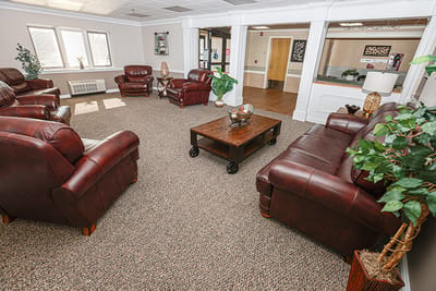 Cozy common area with leather sofas and carpet