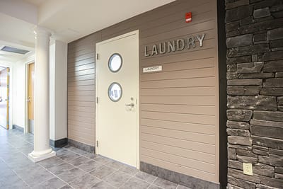 Laundry room entrance with a stone wall