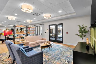 Bright common area with seating and game tables