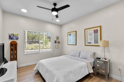 Bright bedroom with a double bed and wall art
