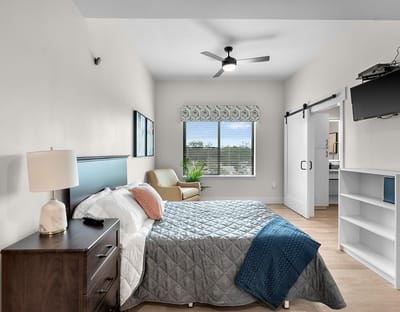 A cozy private resident room with window and furniture