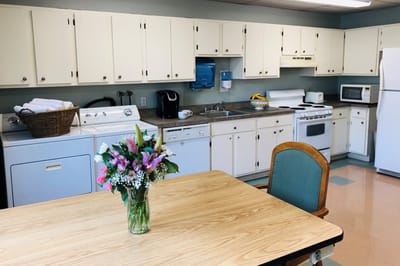 Bright kitchen area with a dining table and flowers