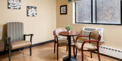 A cozy sitting area with chairs and a table