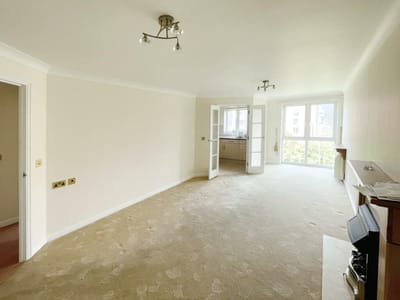 Bright empty living room with large windows