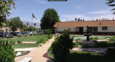 Outdoor view of Brookside Rehabilitation Center with gardens and landscaping