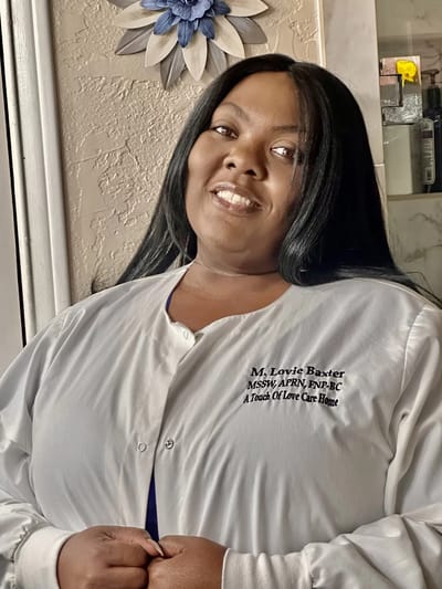Staff member wearing a care home uniform, smiling
