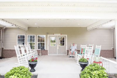 Resident enjoying the porch with rocking chairs