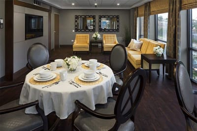 Interior of a common area with seating and dining setup
