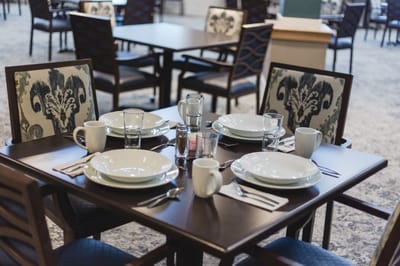 Dining setup with plates and utensils at a dining table
