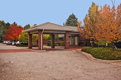 Entrance of Orchard Park Health Care Center with autumn trees