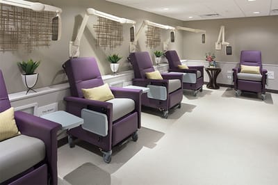 Interior seating area with purple recliners and plants