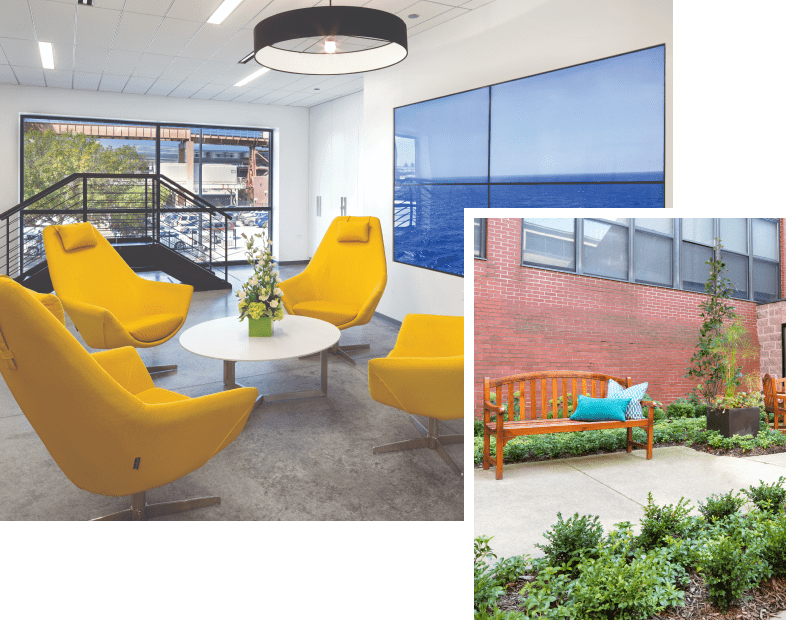 Bright common area with yellow chairs and large windows