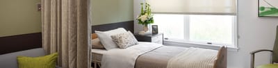 Interior view of a private resident room with a bed