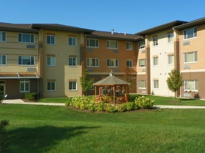 View of the facility exterior featuring a gazebo and garden