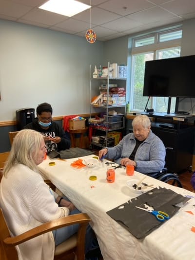 Residents engaged in a crafting activity in a common area