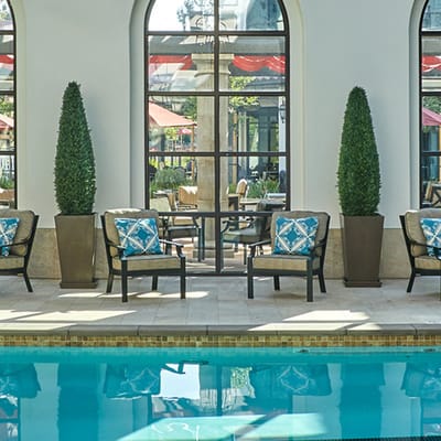 Indoor pool area with seating and plants