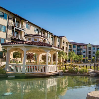 Exterior view of a senior living facility with outdoor gazebo