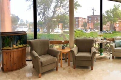 Bright common area with seating and an aquarium