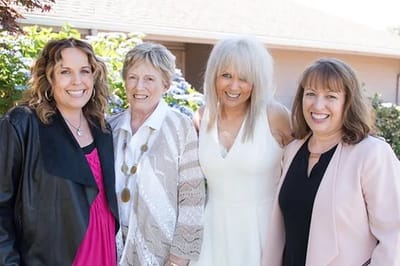 Residents and staff smiling together outdoors