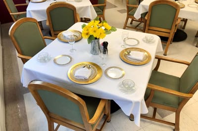 Elegantly set dining table with flowers and glassware