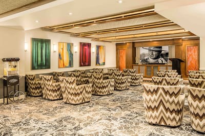 Interior seating area with patterned chairs and artwork