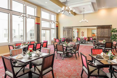Bright dining room with tables set for meals