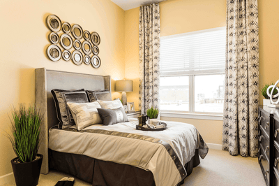 A well-decorated resident room with a bed and window
