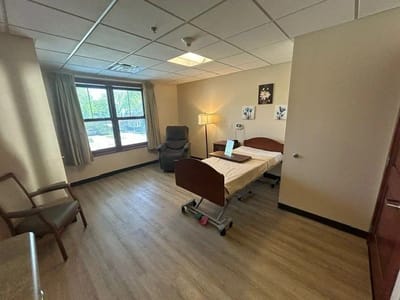 Bright resident room with bed and window