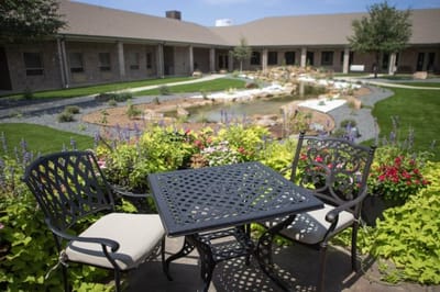 A serene outdoor area with seating and landscaping