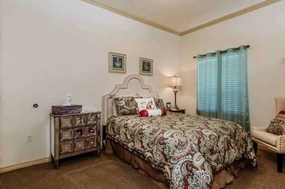 Cozy bedroom featuring decorative bedding and a lamp