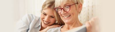 Smiling resident and caregiver sharing a moment.