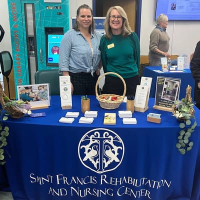 Staff members at a table with informational materials.