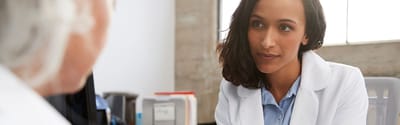 Healthcare professional speaking with a resident