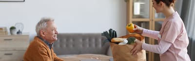Resident interacting with staff member in a communal space