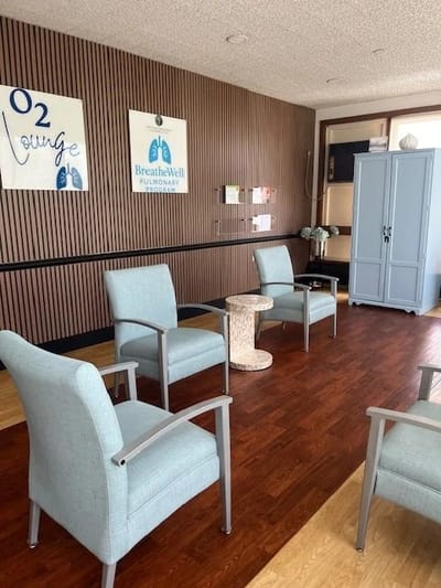 Common area with seating and decorative wall signs.