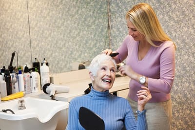 Resident enjoying a hair salon service.