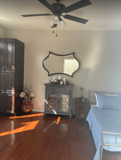 Cozy resident room with wood flooring and decor.