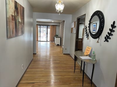 Interior hallway with a chandelier and decor
