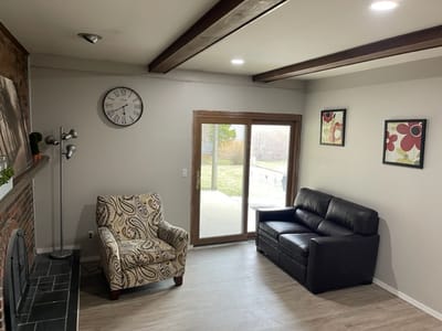 Cozy common area with seating and large windows.