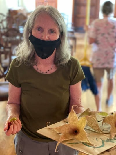 Resident holding a display of starfish in a common area.