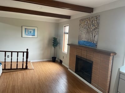 Interior common area with wood flooring and artwork.