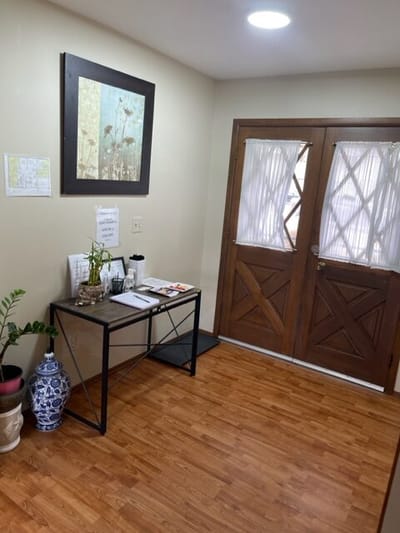 Interior entrance with a table and artwork.