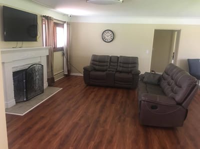 Cozy living area with chairs and a fireplace.