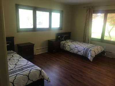 Private resident room with two beds and natural light.