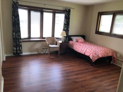 Private resident room with bed and chair
