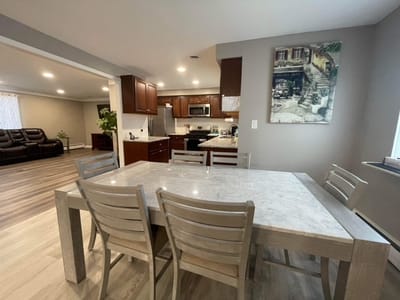 A dining area with a large table and chairs.
