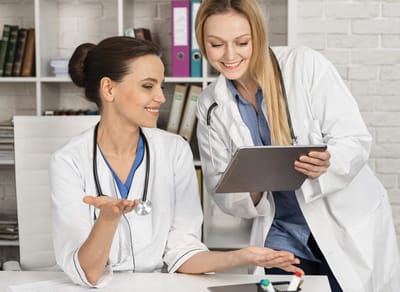 Two healthcare professionals discussing patient care.