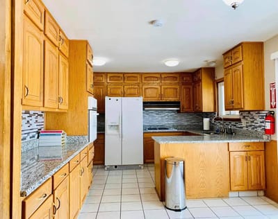 Modern kitchen space with wooden cabinets and appliances.