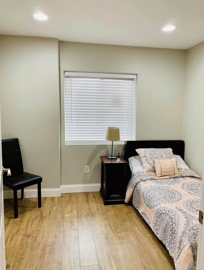 Private room with bed and chair