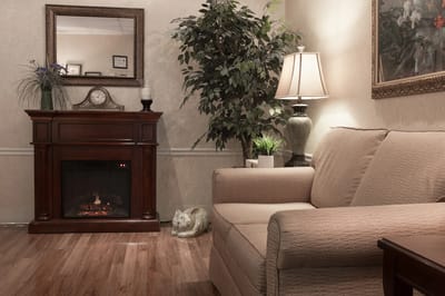 Cozy lounge area with a couch and lamp.